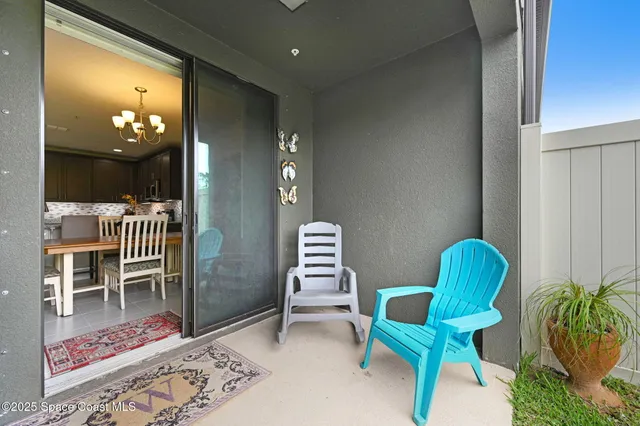 a hallway with chairs and a potted plant