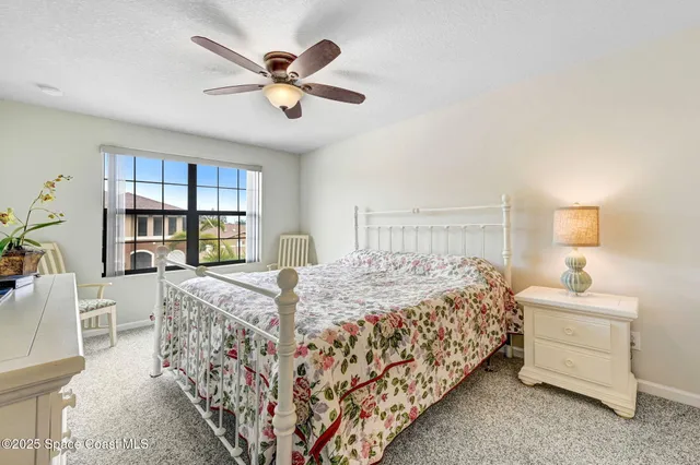 a bedroom with a bed a dresser and book shelf