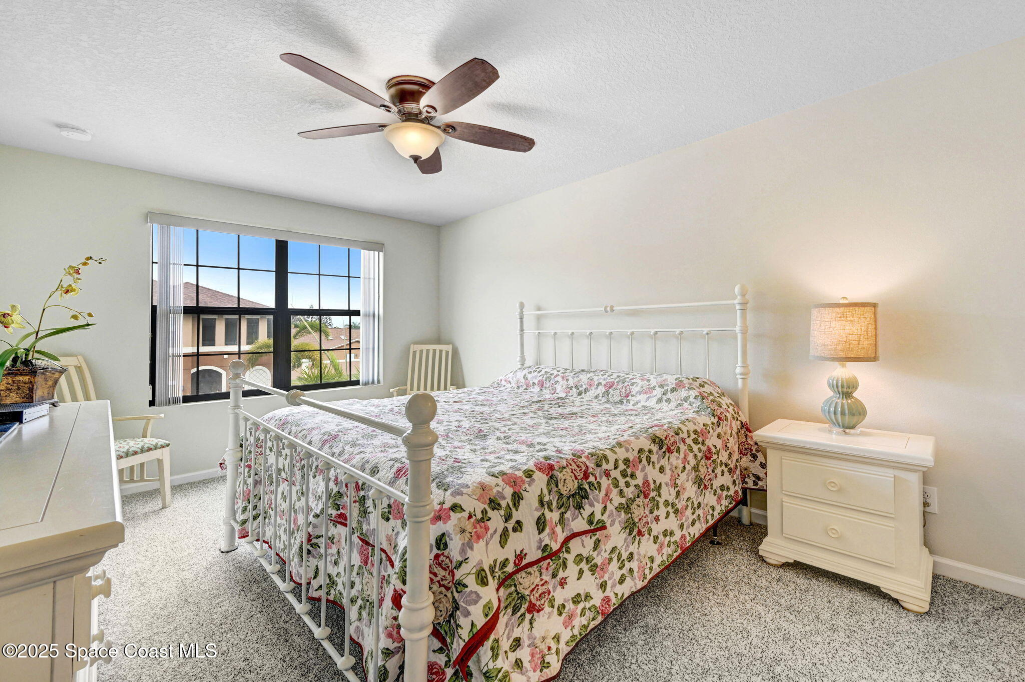 1430 Lara Circle, Unit 103 Rockledge, FL 32955 - Photo 25 of 39 a bedroom with a bed a dresser and book shelf