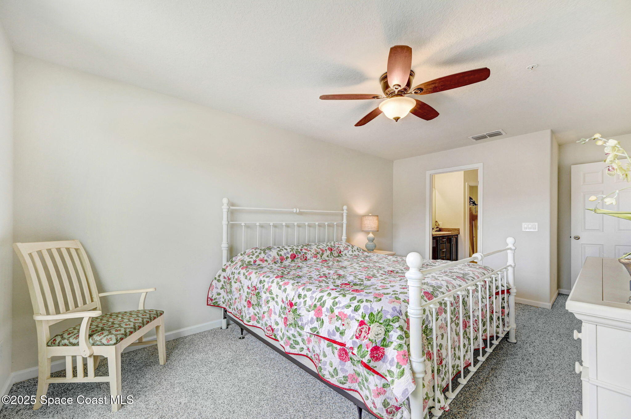 1430 Lara Circle, Unit 103 Rockledge, FL 32955 - Photo 26 of 39 a bedroom with a bed and a chandelier