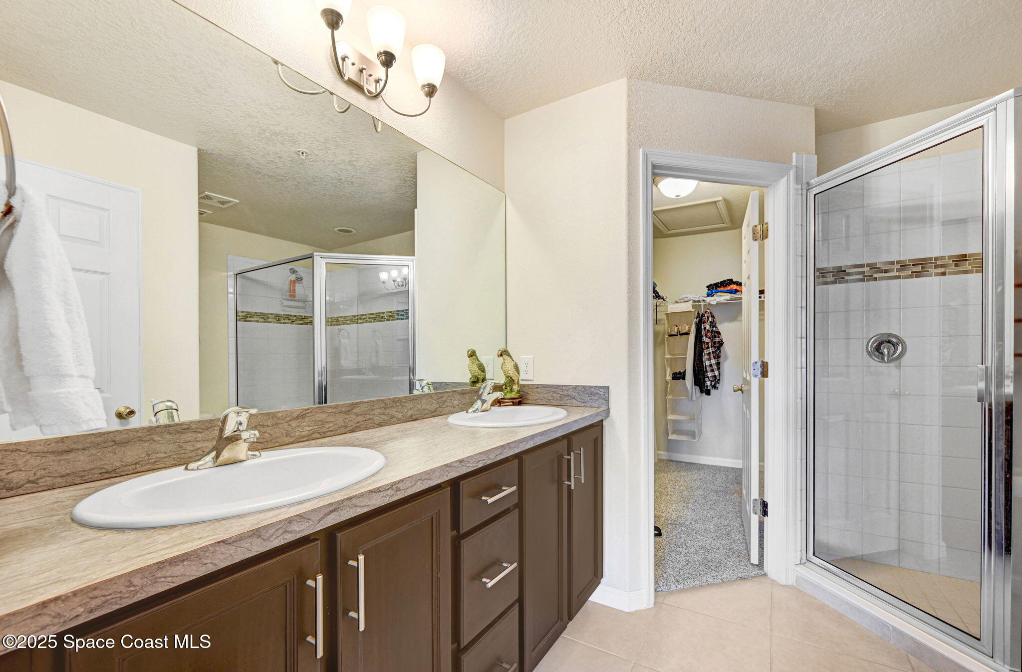 1430 Lara Circle, Unit 103 Rockledge, FL 32955 - Photo 27 of 39 a bathroom with a sink double vanity and a mirror
