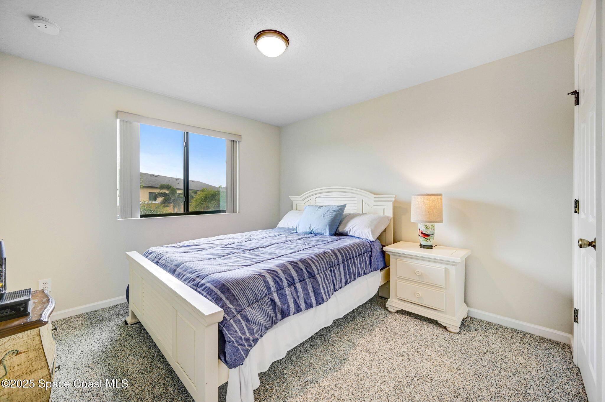 1430 Lara Circle, Unit 103 Rockledge, FL 32955 - Photo 31 of 39 a bedroom with a bed and window