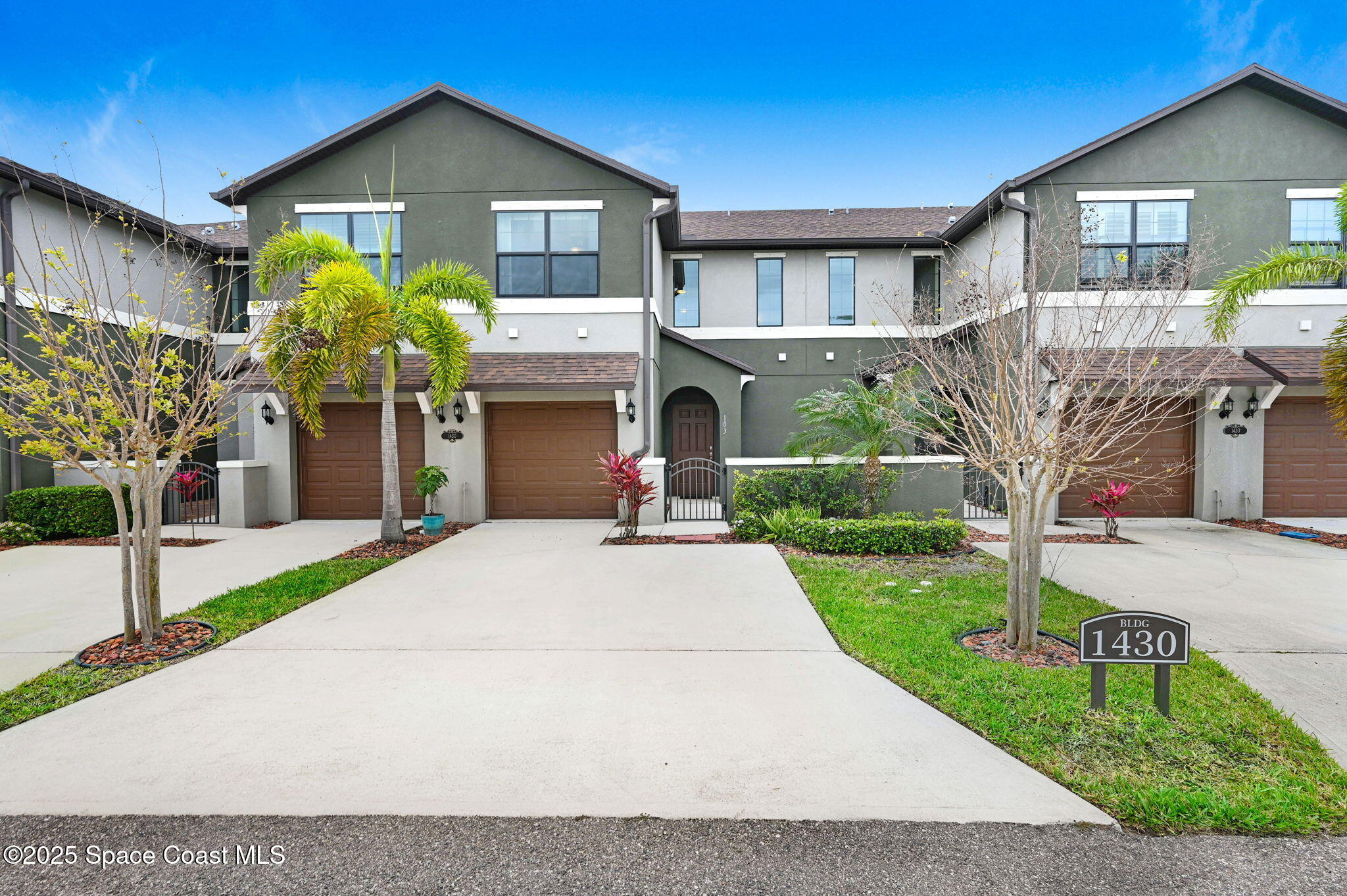 1430 Lara Circle, Unit 103 Rockledge, FL 32955 - Photo 33 of 39 a front view of a house with a yard and garage