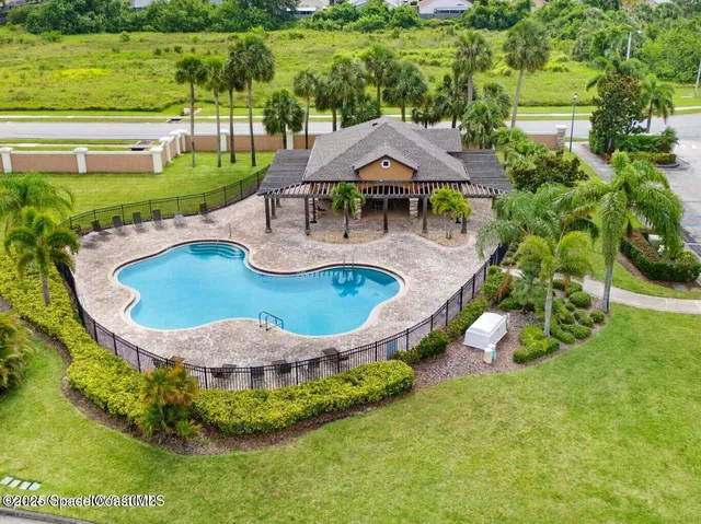 an aerial view of a house with swimming pool garden and outdoor seating