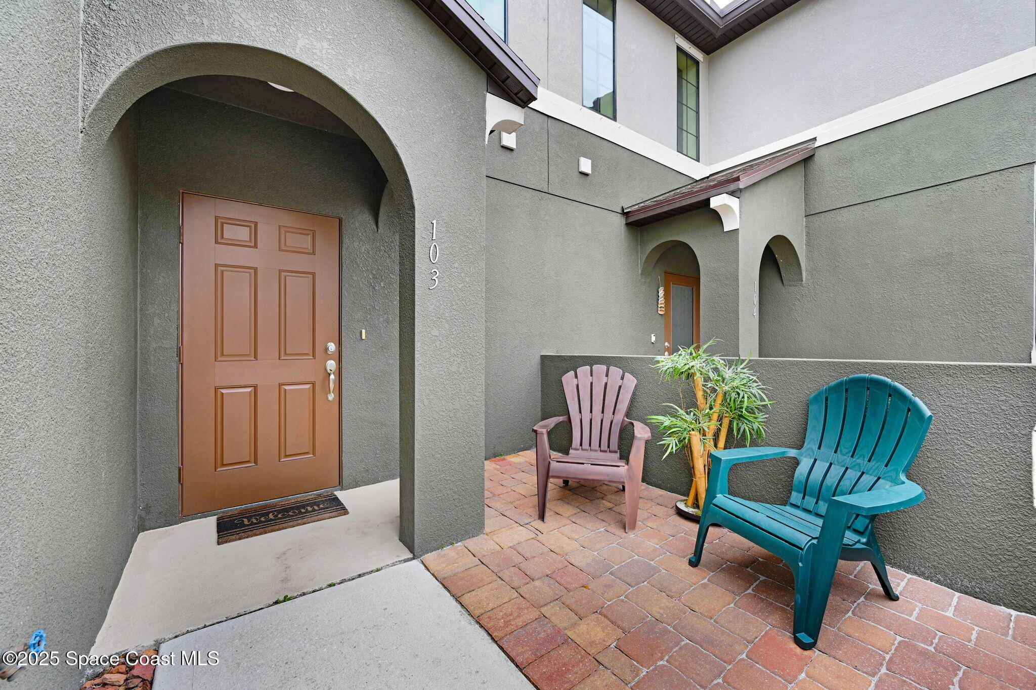 1430 Lara Circle, Unit 103 Rockledge, FL 32955 - Photo 4 of 39 a bedroom with a bed and a chair