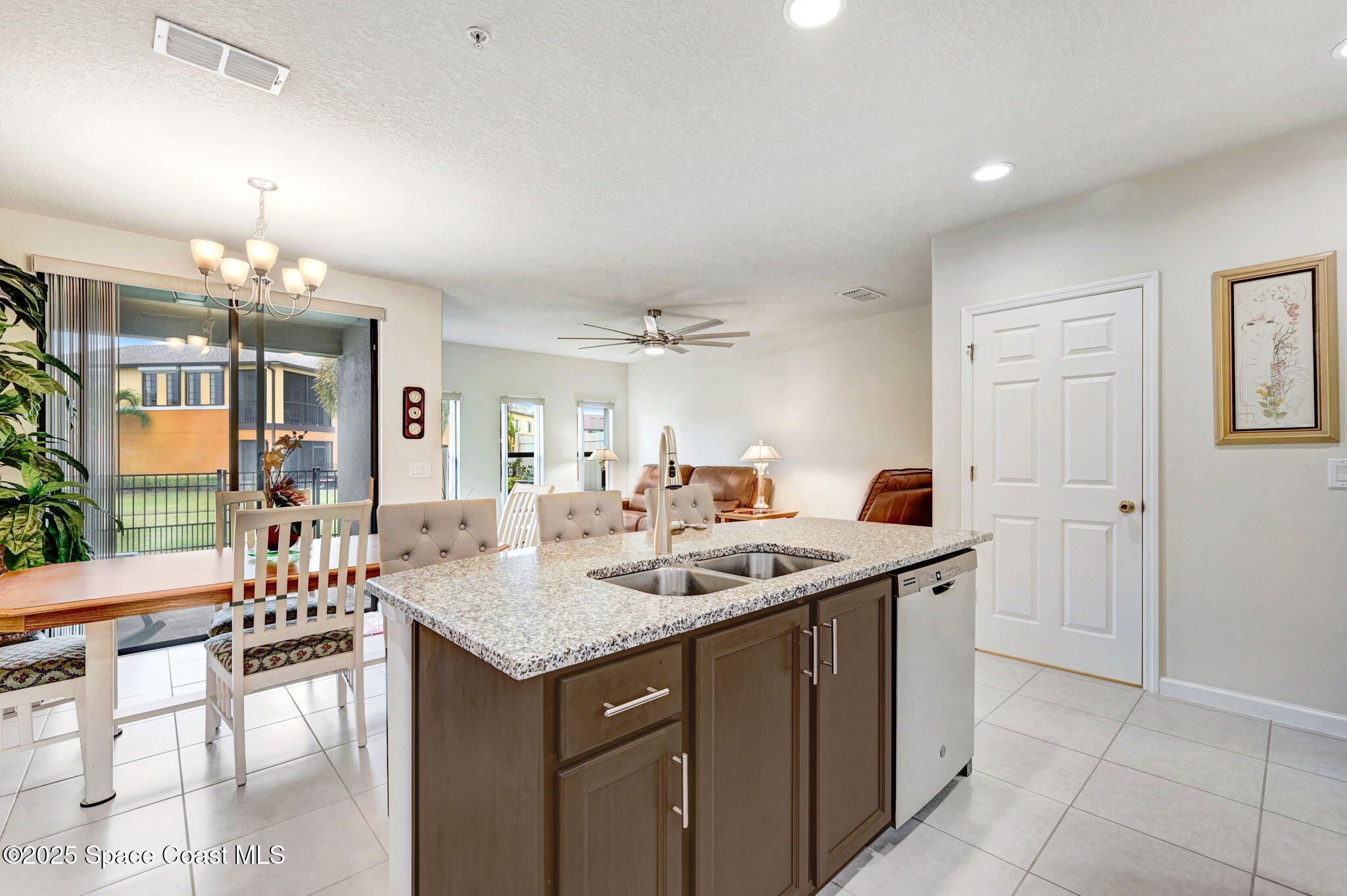 1430 Lara Circle, Unit 103 Rockledge, FL 32955 - Photo 10 of 39 a kitchen with a counter space dining table and chairs