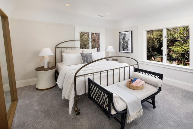 a bedroom with furniture and a window