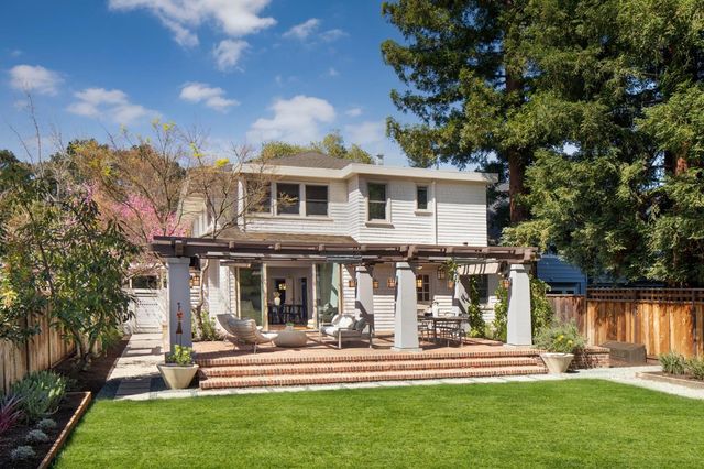 a front view of a house with a yard table and chairs
