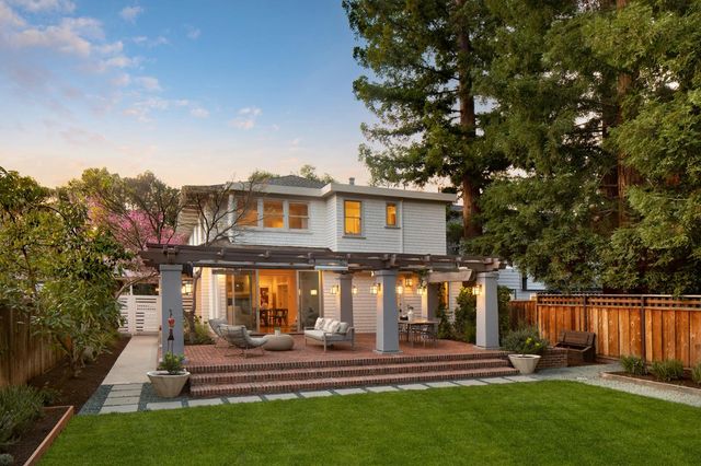 a front view of a house with a yard table and chairs