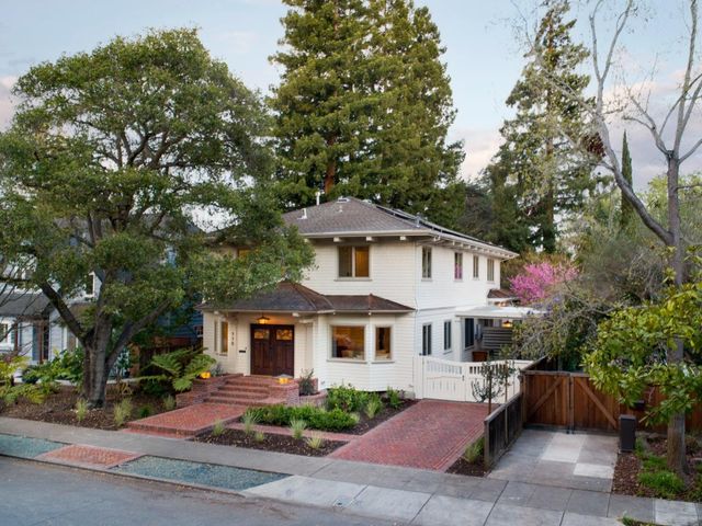 a front view of a house with a garden