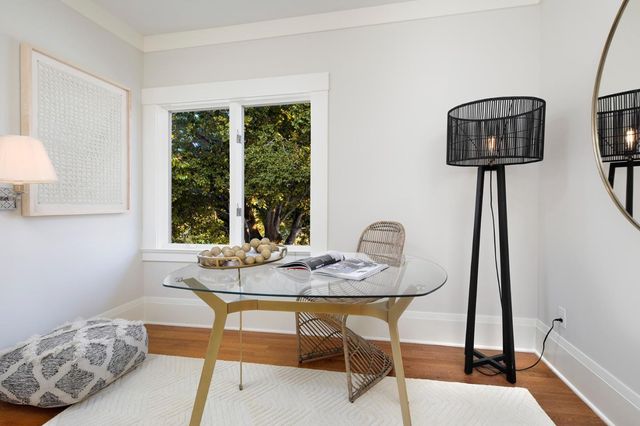 a dining room with furniture and wooden floor