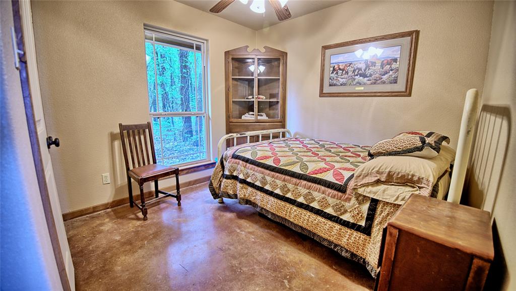 4509 Lazy E Road St. Jo, TX 76265 - Photo 26 of 39 a bedroom with a bed and a window