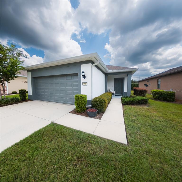 7235 Southwest 91st Court Ocala, FL 34481 - Photo 1 of 23 a view of a white house with a yard and potted plants