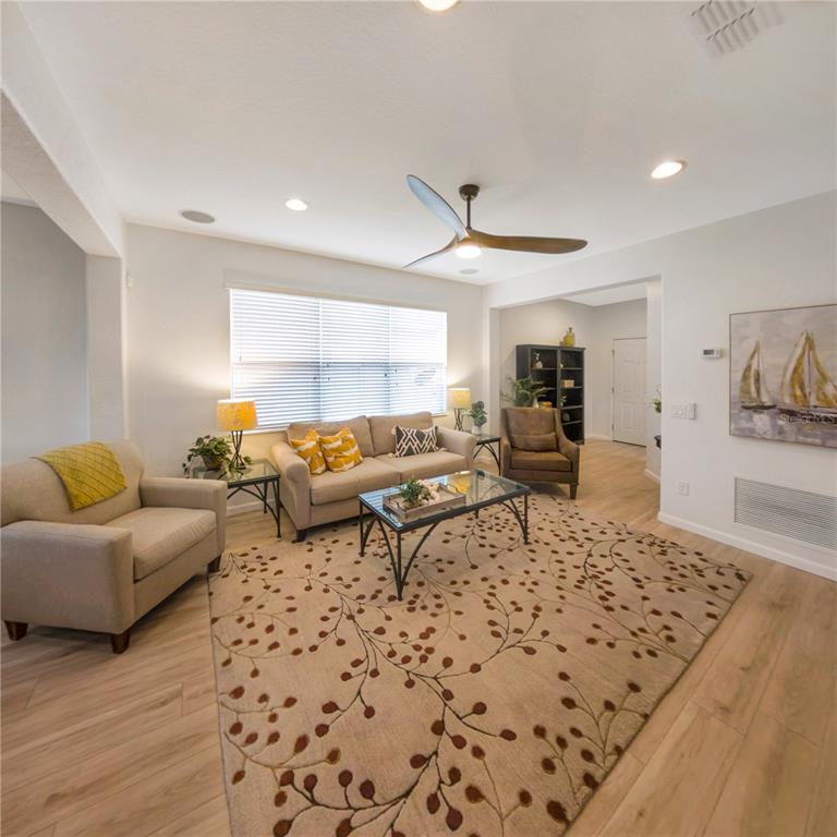 7235 Southwest 91st Court Ocala, FL 34481 - Photo 13 of 23 a living room with furniture and a rug