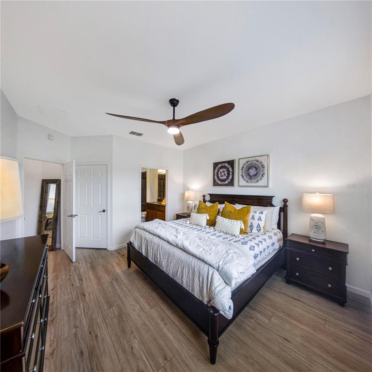 7235 Southwest 91st Court Ocala, FL 34481 - Photo 16 of 23 a bedroom with a bed and wooden floor