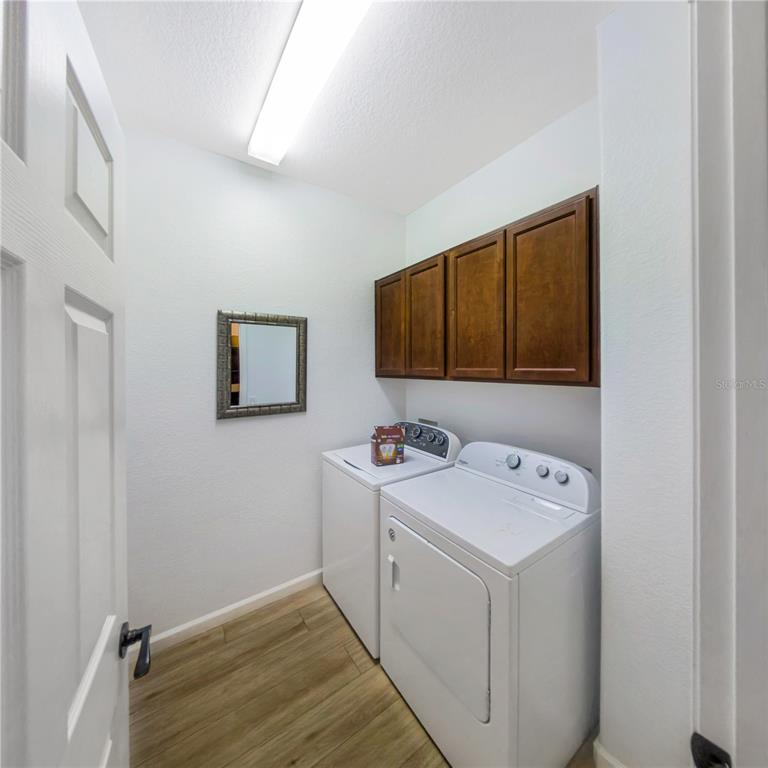 7235 Southwest 91st Court Ocala, FL 34481 - Photo 18 of 23 a utility room with dryer and washer