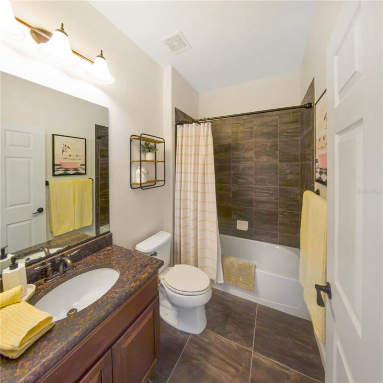 7235 Southwest 91st Court Ocala, FL 34481 - Photo 20 of 23 a bathroom with a sink a toilet a mirror and shower