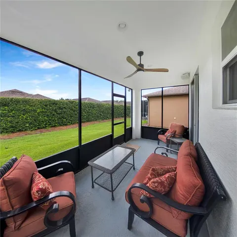 a living room with furniture and a floor to ceiling window