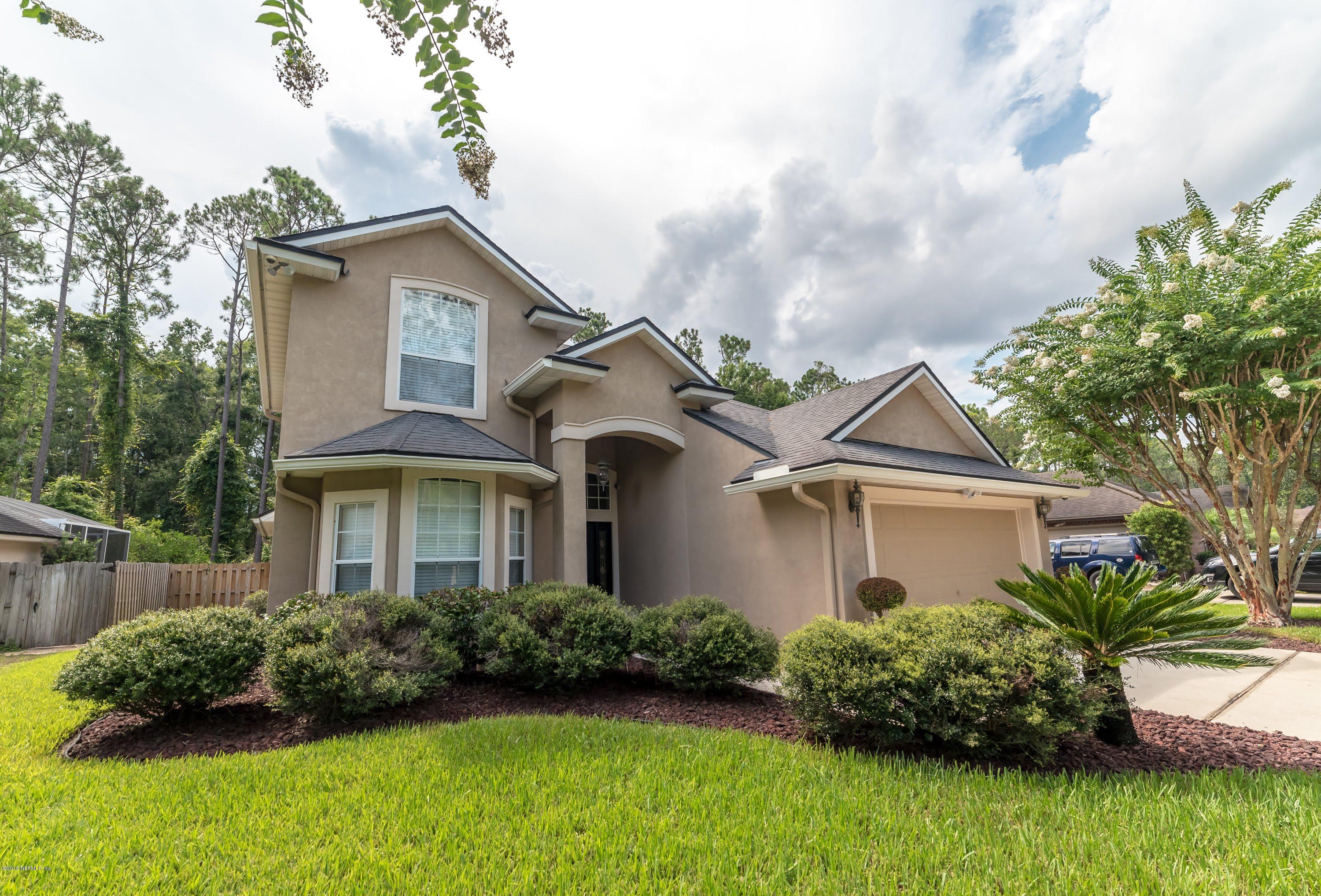 8964 Timberjack Lane Jacksonville, FL 32256 - Photo 1 of 23 a front view of a house with a garden