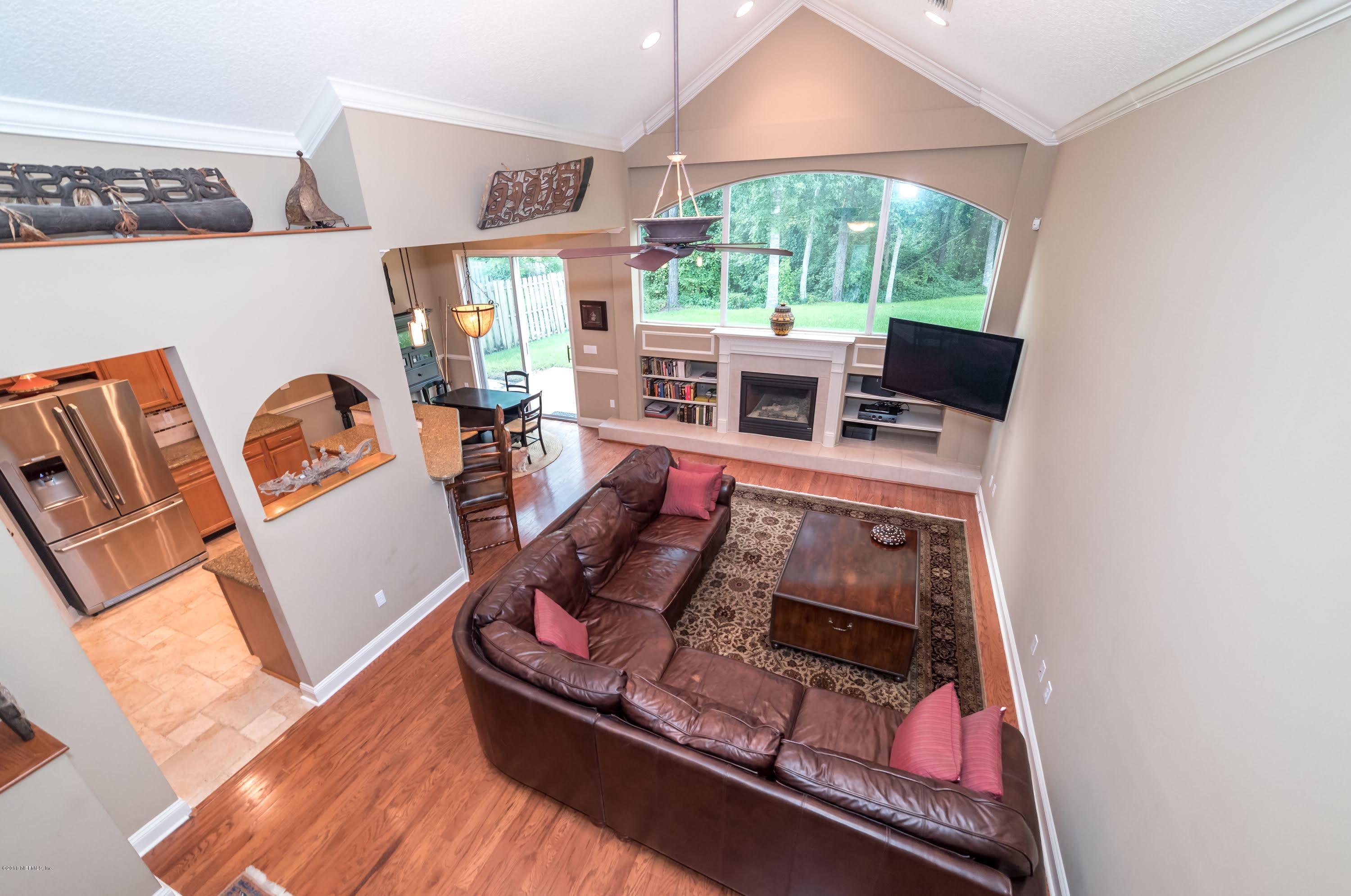 8964 Timberjack Lane Jacksonville, FL 32256 - Photo 11 of 23 a living room with furniture and a fireplace