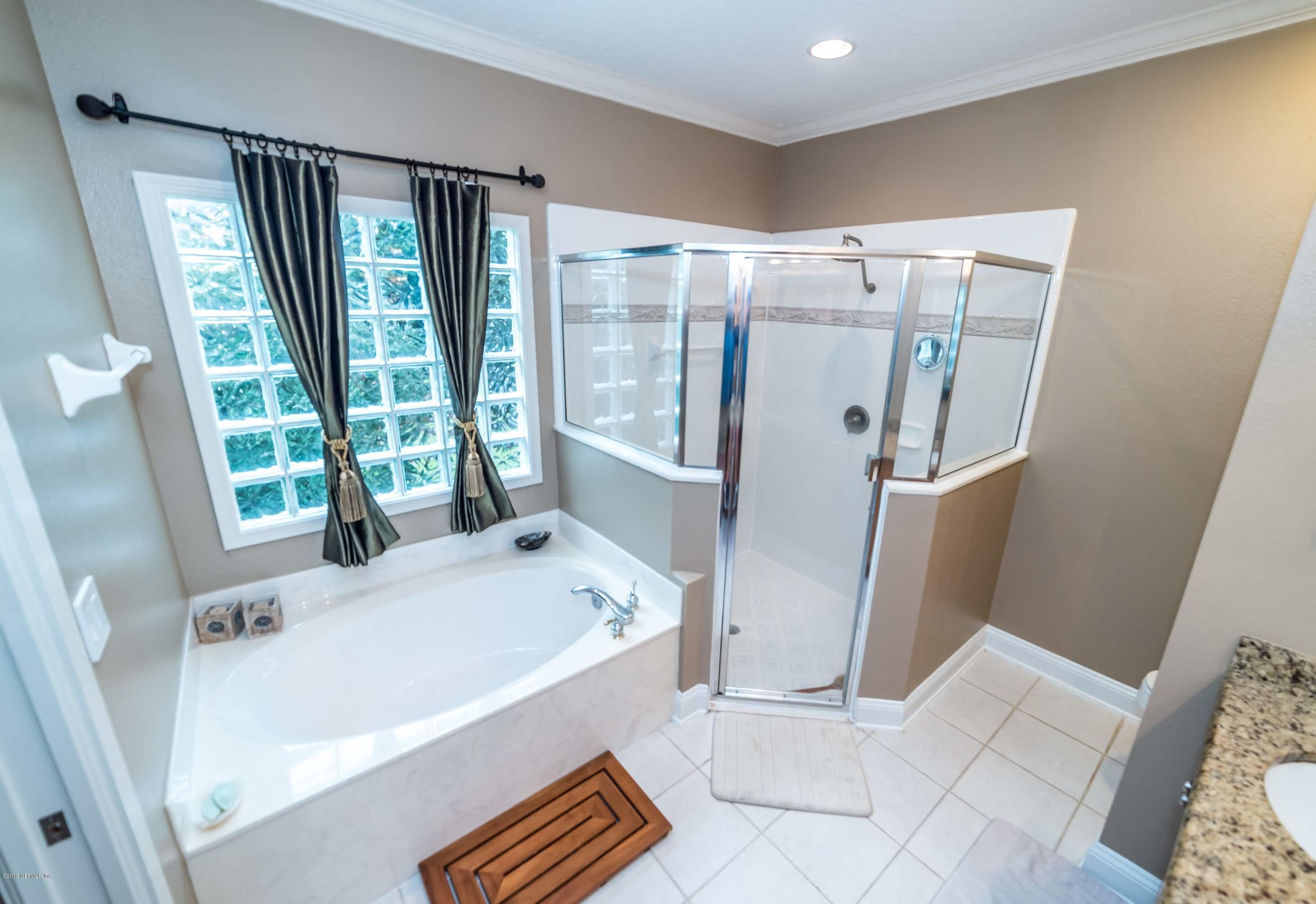 8964 Timberjack Lane Jacksonville, FL 32256 - Photo 14 of 23 a bathroom with a bathtub and a sink