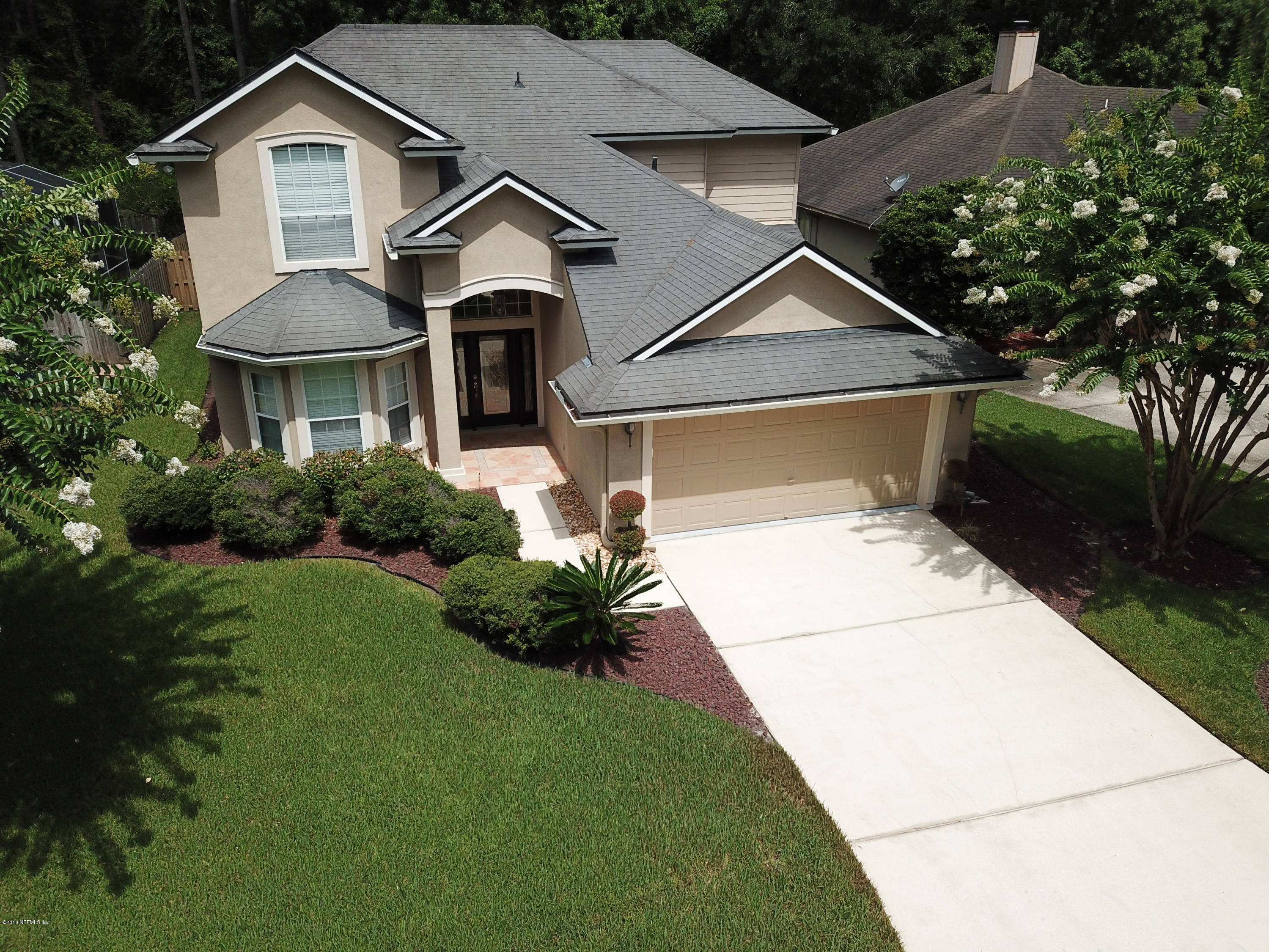 8964 Timberjack Lane Jacksonville, FL 32256 - Photo 2 of 23 a front view of a house with garden