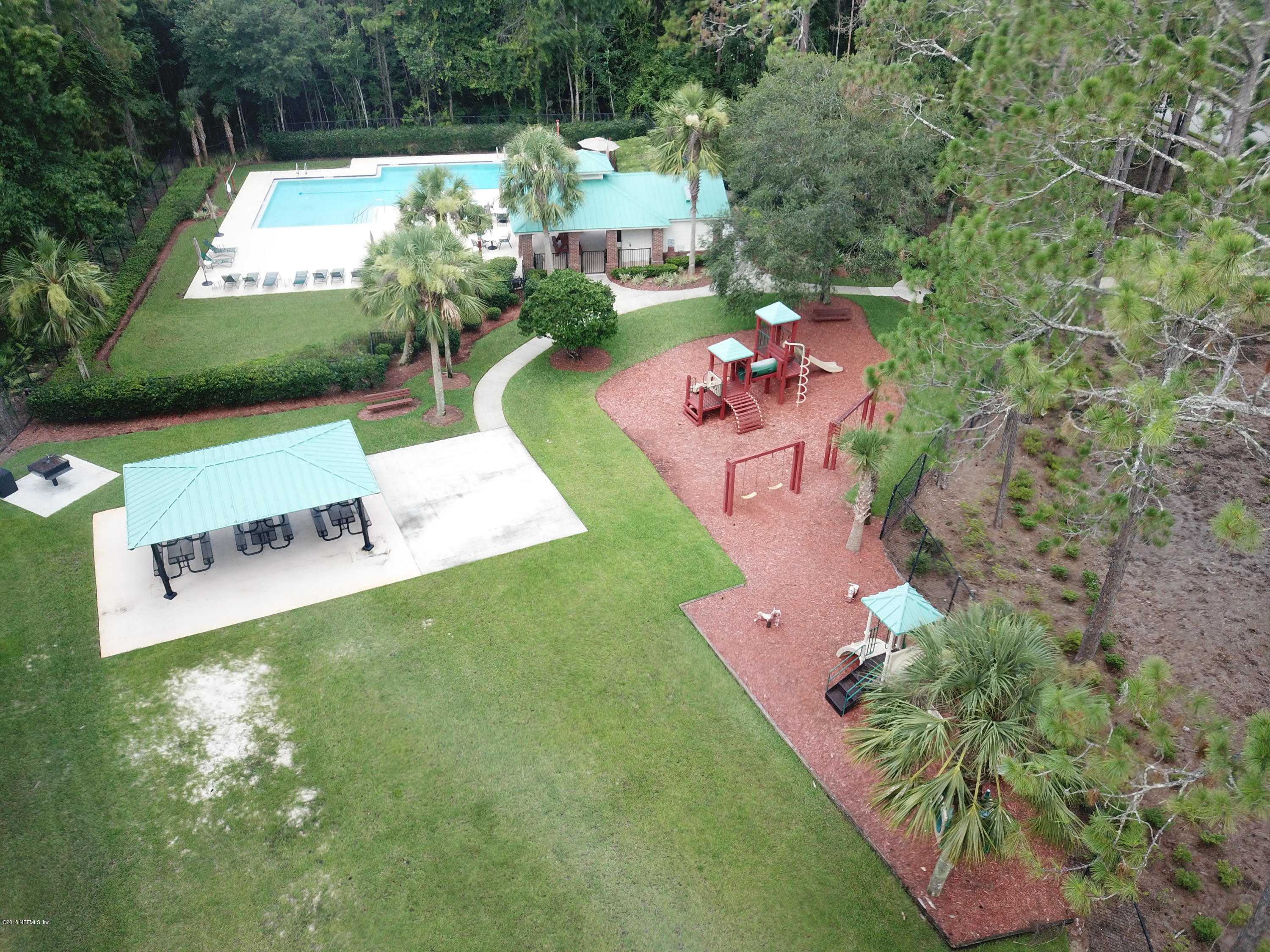 8964 Timberjack Lane Jacksonville, FL 32256 - Photo 22 of 23 a picture of a yard with an outdoor seating