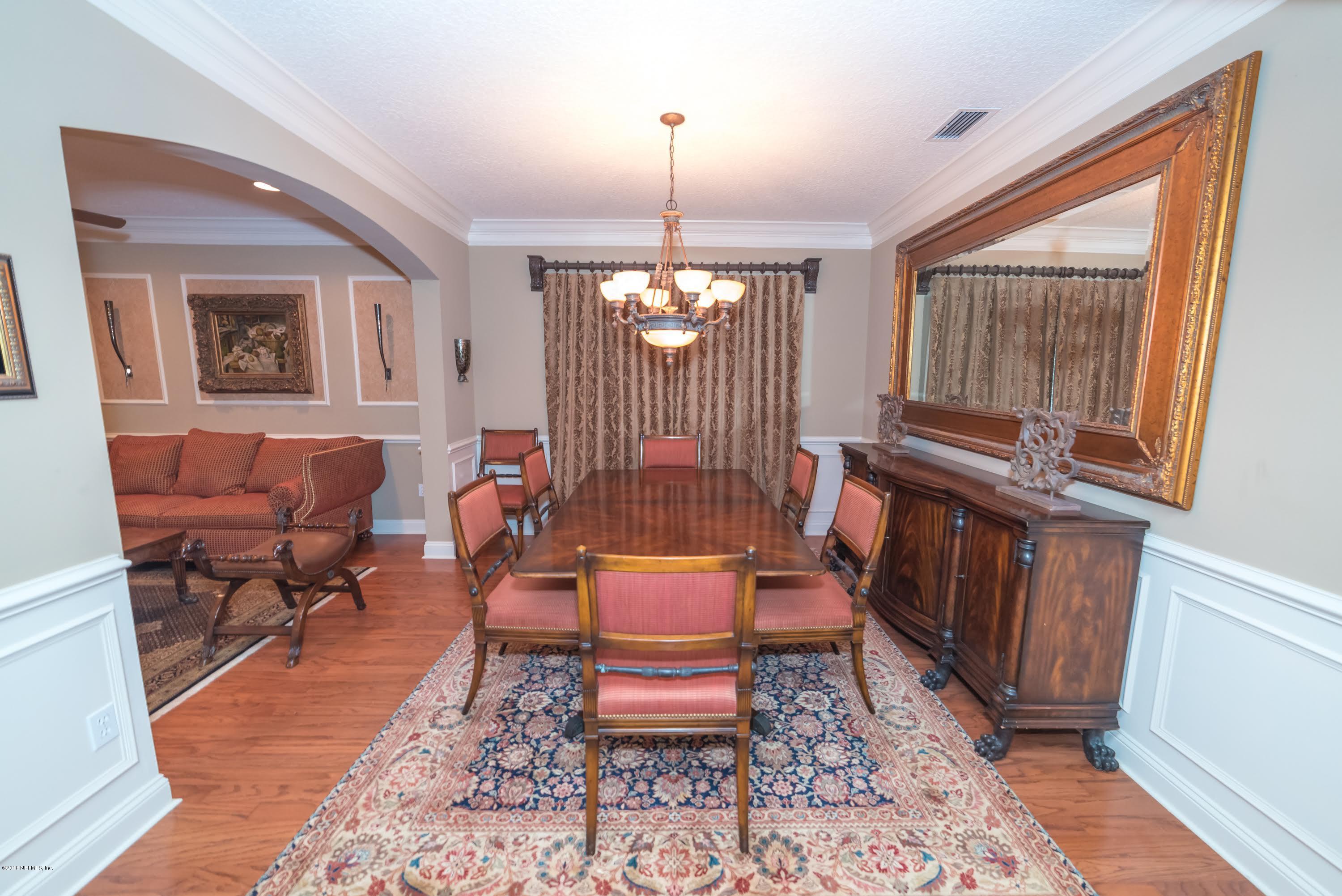 8964 Timberjack Lane Jacksonville, FL 32256 - Photo 6 of 23 a living room with furniture a window and a chandelier