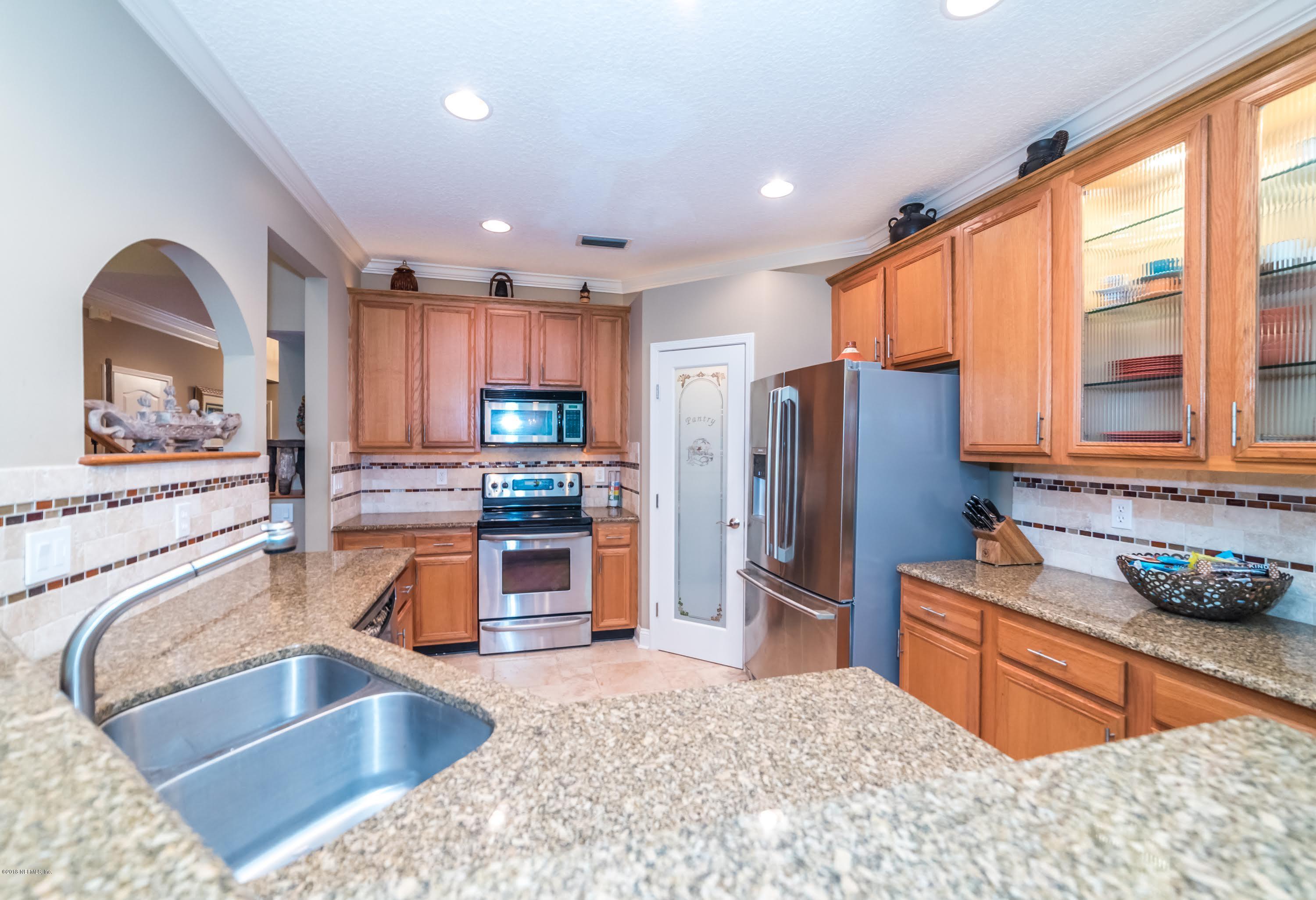8964 Timberjack Lane Jacksonville, FL 32256 - Photo 7 of 23 a kitchen with stainless steel appliances granite countertop a refrigerator and a sink