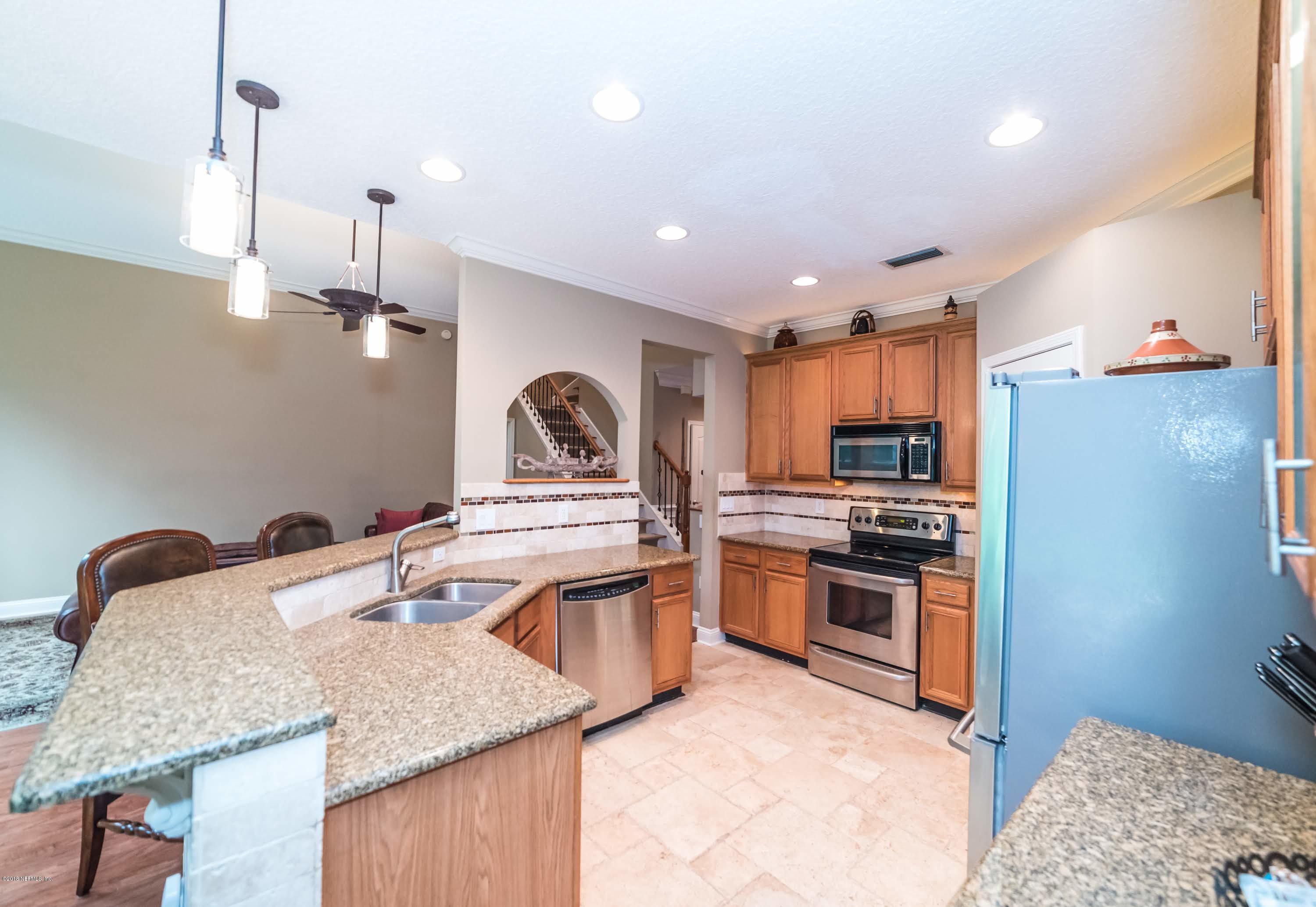 8964 Timberjack Lane Jacksonville, FL 32256 - Photo 8 of 23 a kitchen with stainless steel appliances granite countertop a sink stove and refrigerator