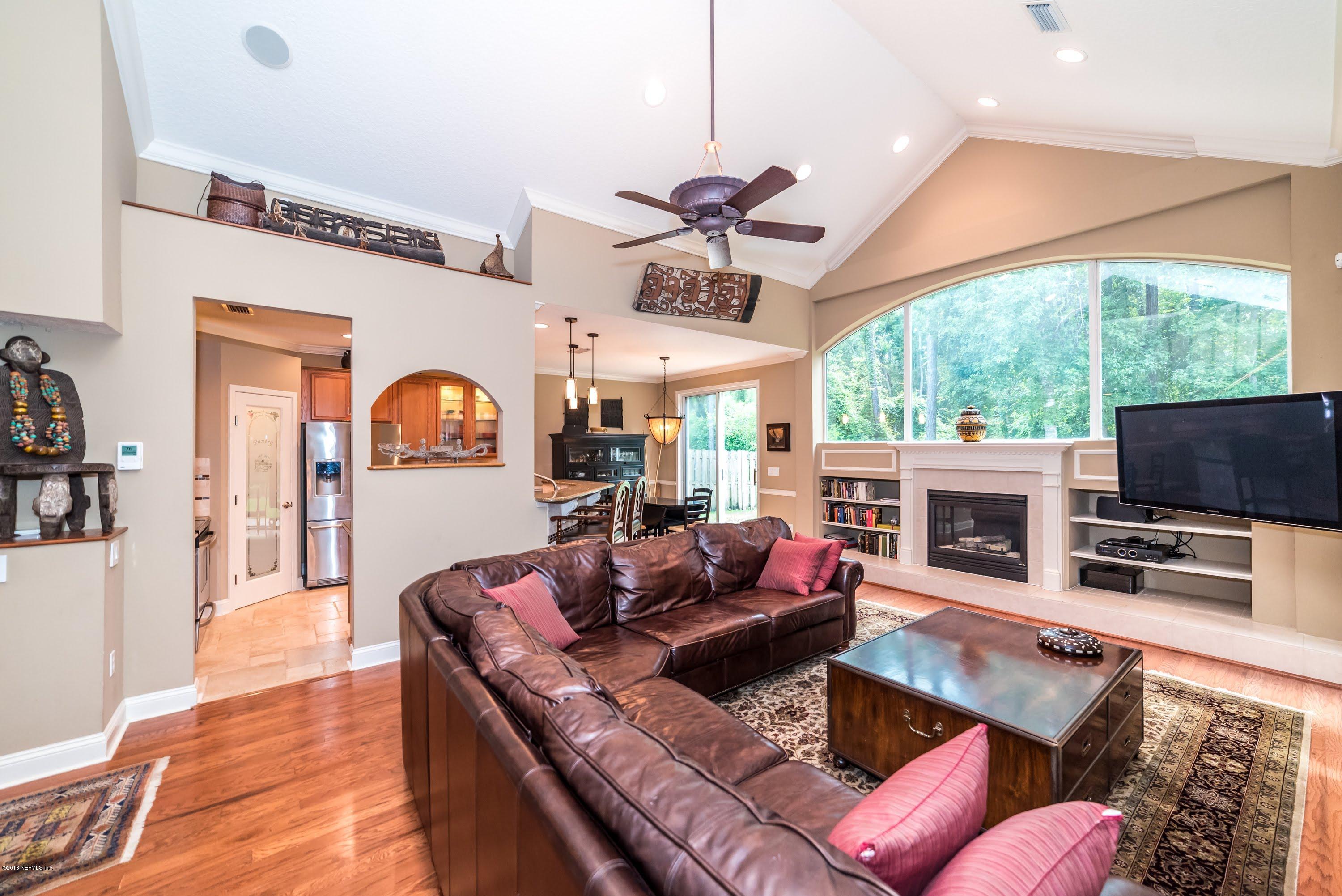 8964 Timberjack Lane Jacksonville, FL 32256 - Photo 10 of 23 a living room with fireplace furniture and a flat screen tv