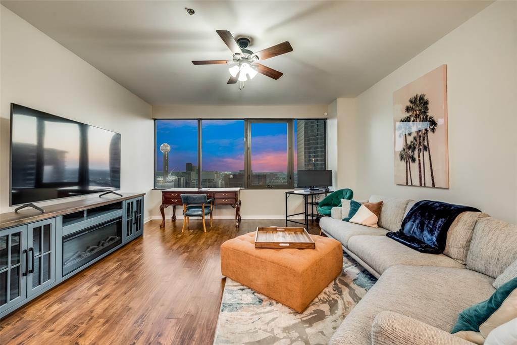 a living room with furniture and a flat screen tv