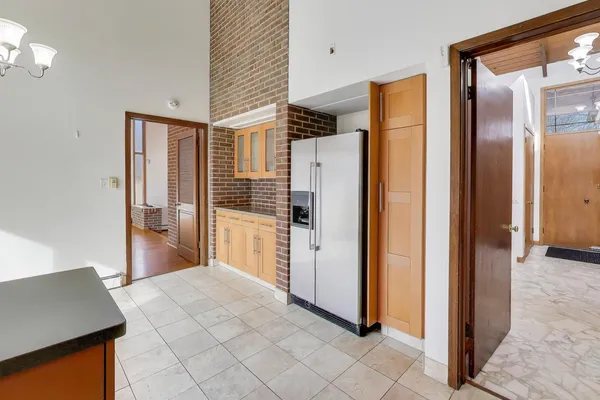a kitchen with stainless steel appliances granite countertop a refrigerator and a stove top oven