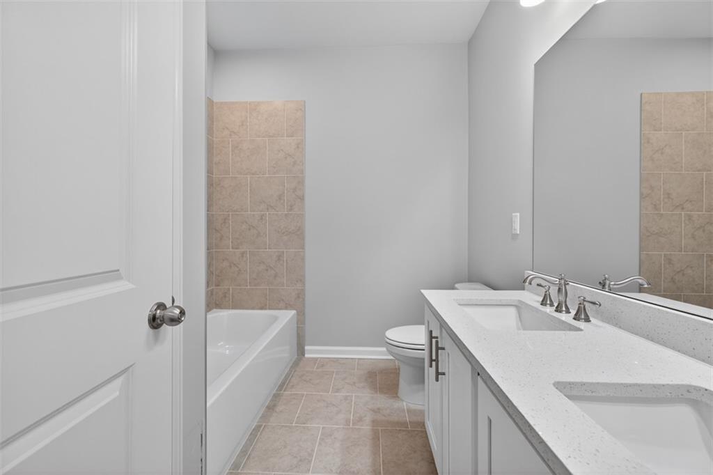 8845 Jot Em Down Road Gainesville, GA 30506 - Photo 44 of 87 a bathroom with a sink a toilet and shower