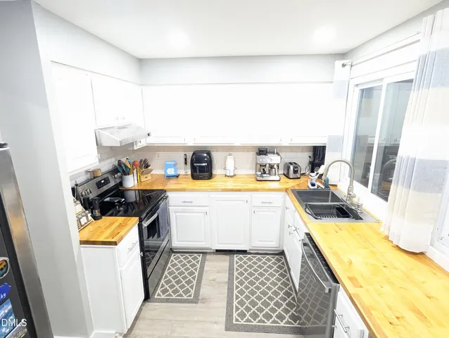 a kitchen with a stove a refrigerator and a stove