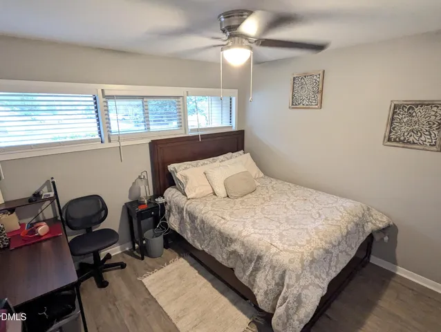 a bedroom with a bed and a desk