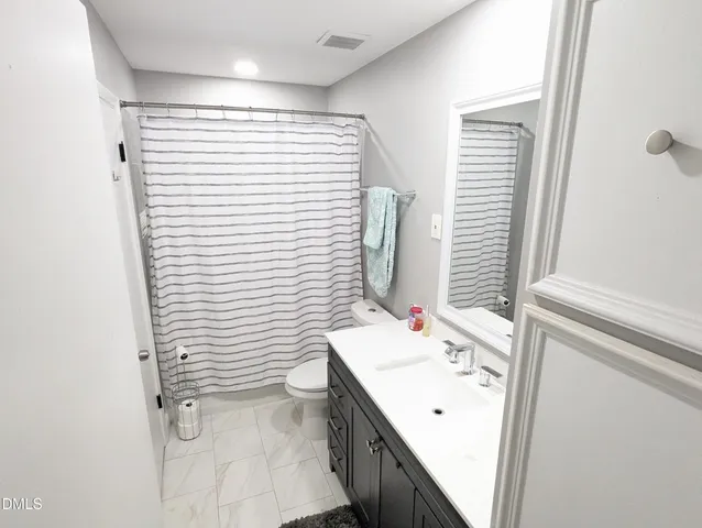 a bathroom with a sink a mirror and a shower