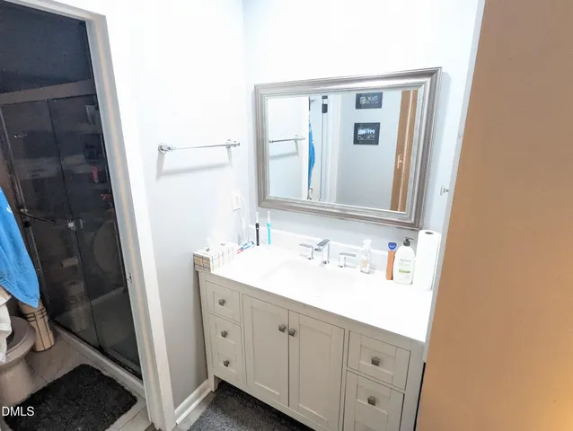 a bathroom with a double vanity sink and mirror