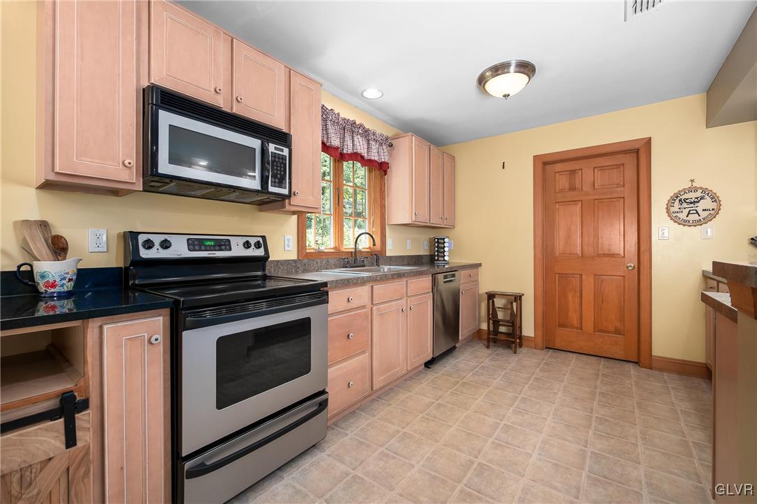 2413 Point Phillips Road Kunkletown, PA 18058 - Photo 18 of 48 a kitchen with stainless steel appliances granite countertop a stove a microwave and a refrigerator
