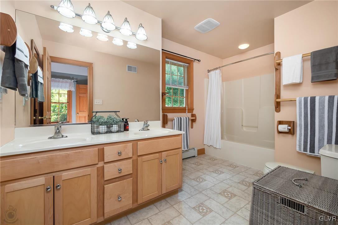 2413 Point Phillips Road Kunkletown, PA 18058 - Photo 27 of 48 a spacious bathroom with a granite countertop sink a mirror and a shower