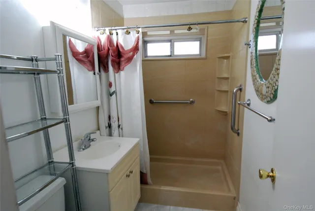 a bathroom with a sink a mirror and a shower