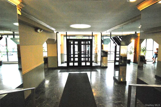 a view of entryway with a floor to ceiling window and wooden floor