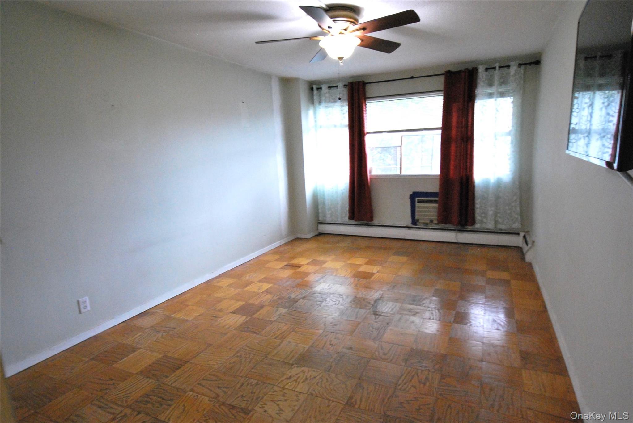 1523 Central Park Avenue, Unit 5F Yonkers, NY 10710 - Photo 10 of 20 a view of an empty room with a window