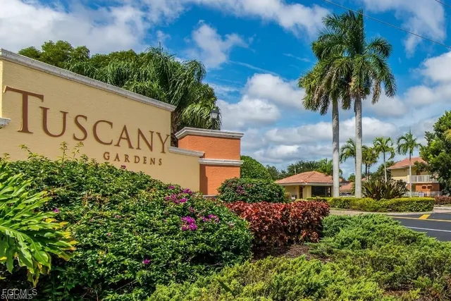 a view of sign board with flower plants