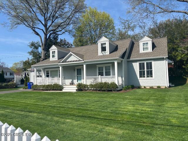 8 Perry Place Riverside, CT 06878 - Photo 2 of 26 a front view of a house with a garden