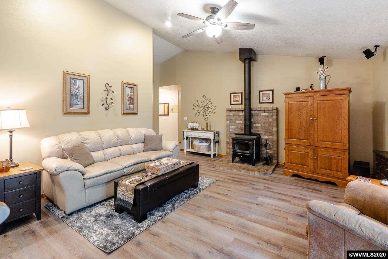 15241 Strong Road Dallas, OR 97338 - Photo 11 of 40 a living room with furniture and a flat screen tv