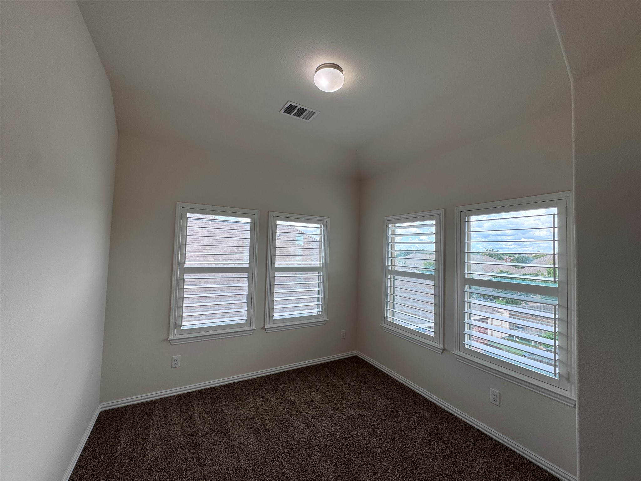 2605 Rough Berry Road Pflugerville, TX 78660 - Photo 32 of 40 Three sun-filled windows offer scenic views from this inviting carpeted room.