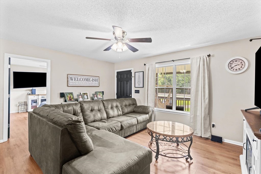 2326 Waring Road Northwest Dalton, GA 30721 - Photo 10 of 41 a living room with furniture a flat screen tv and a window