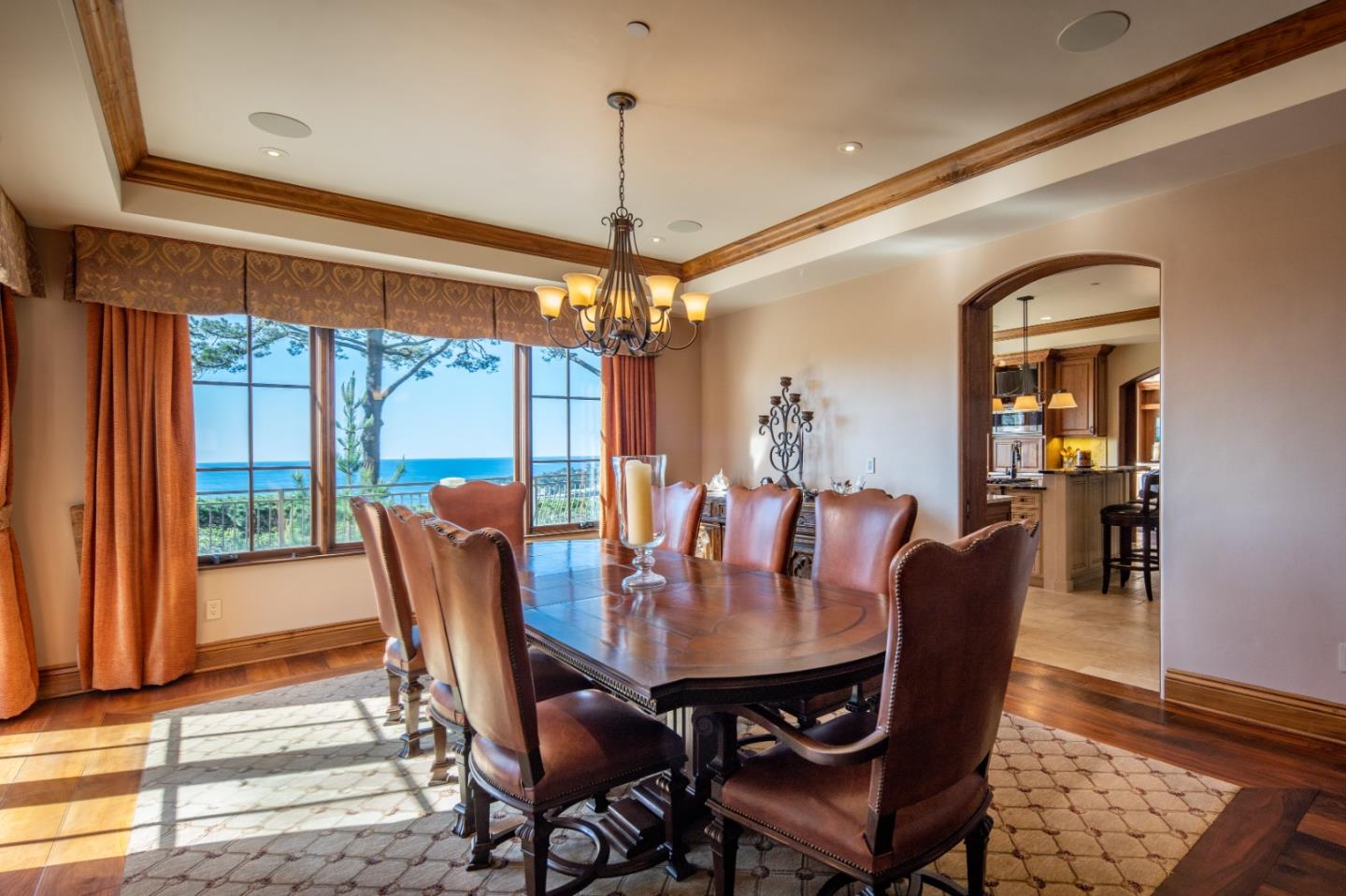3164 Palmero Way Pebble Beach, CA 93953 - Photo 8 of 24 a dining room with furniture a chandelier and wooden floor