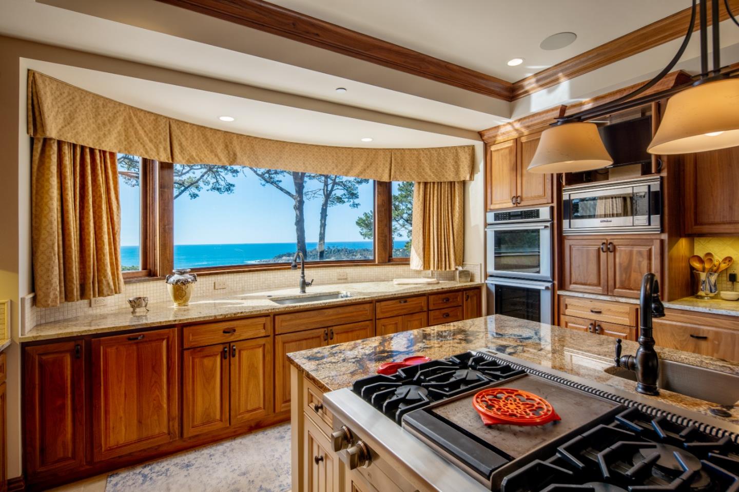 3164 Palmero Way Pebble Beach, CA 93953 - Photo 10 of 24 a kitchen with stainless steel appliances granite countertop a sink stove and cabinets